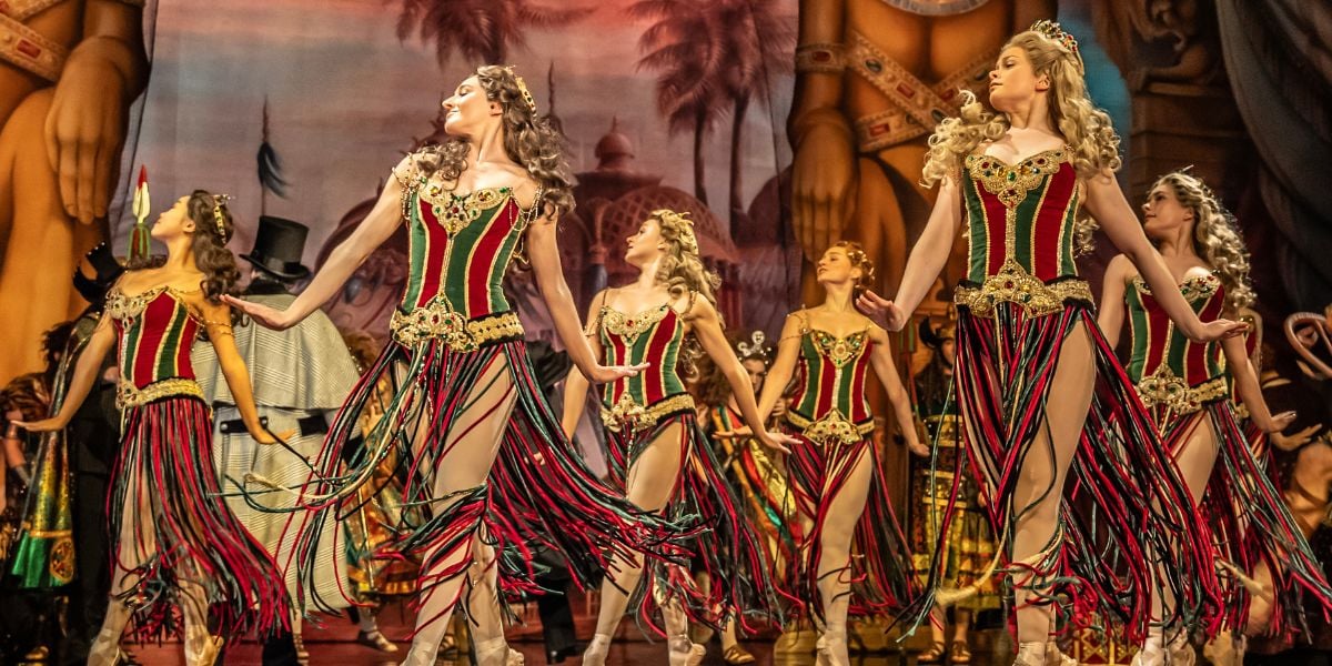 Phantom of the Opera company during a ballet scene. The dancers are stood on pointe shoes dancing.