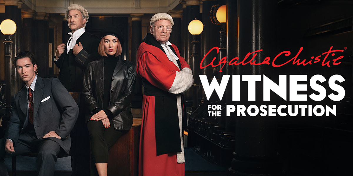 Four people stand behind text reading 'Agatha Christie Witness for the Prosecution'. Two are dressed as judges in wigs and robes, one is a woman dressed all in black, arms folded and the fourth is a man dressed in a suit.