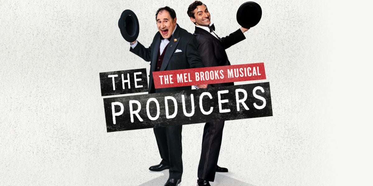 The Producers - The Mel Brooks Musical. Two men pose behind the show title, wearing suits holding out their bowler hats