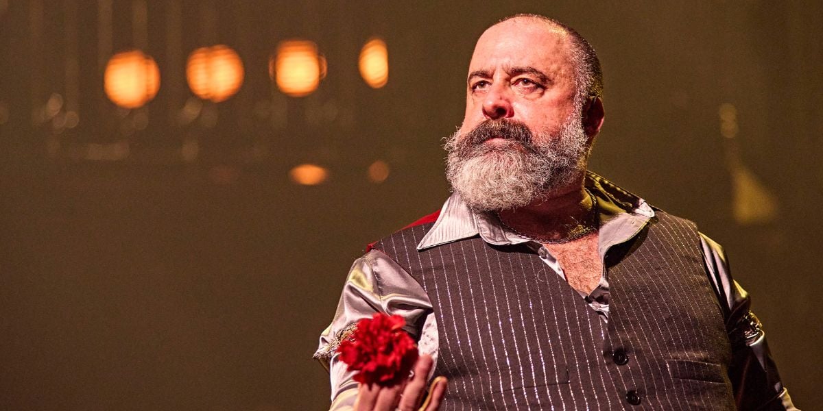 Alastair Parker in Hadestown, holding a red flower. © Brinkhoff-Moegenburg 6