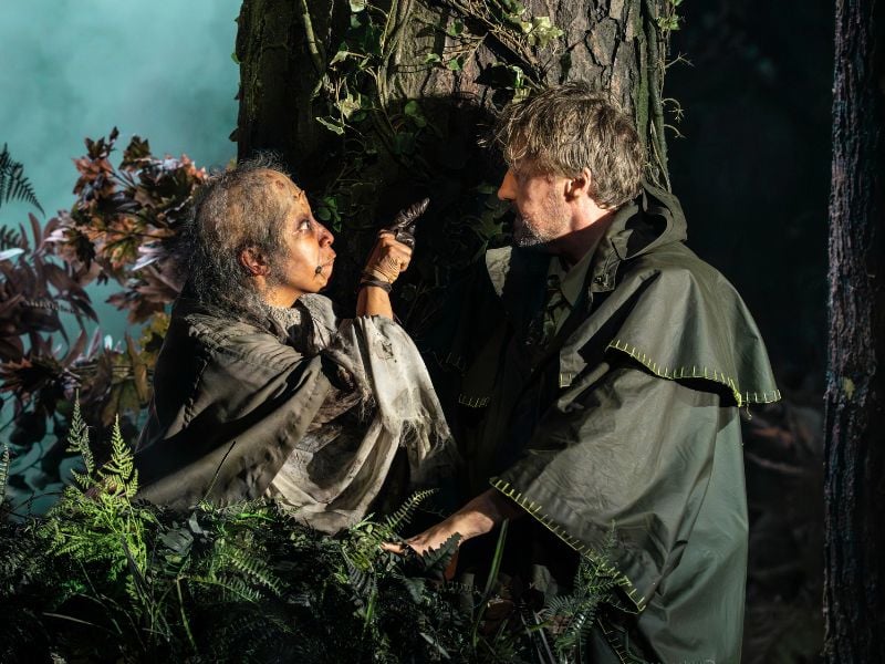 Into The Woods production shot at the Bridge Theatre. From left to right: Melanie La Barrie (Witch) points her finger at Hughie O’Donnell (the Baker). 