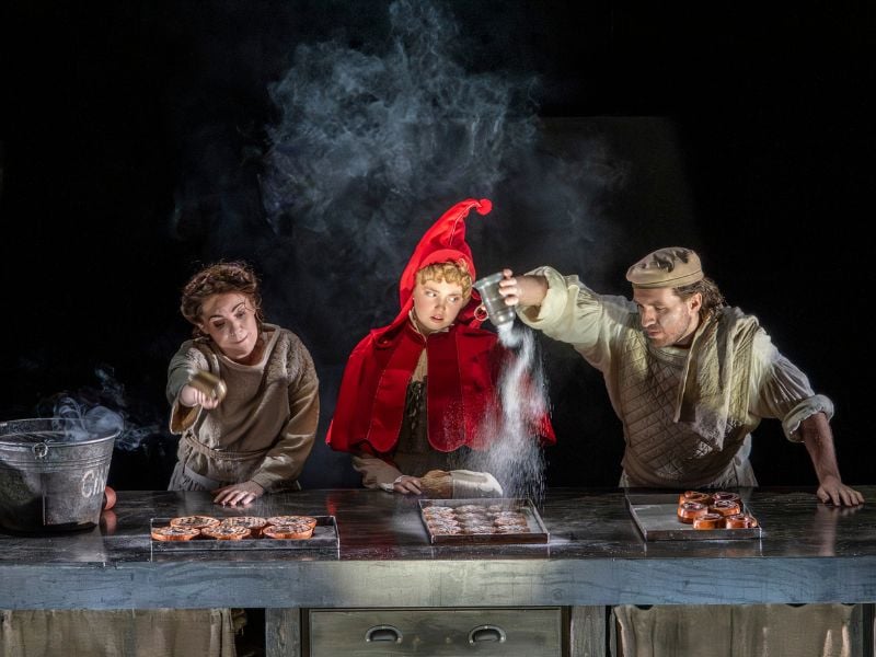 Into The Woods production shot at the Bridge Theatre. From left to right: Rachel Tucker (Baker’s Wife), Gracie McGonigal (Little Red Ridinghood) and Hughie O’Donnell (the Baker). 