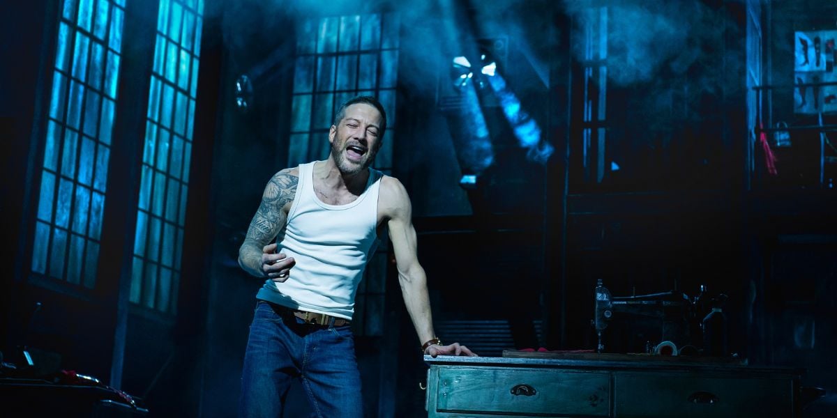 Matt Cardle as Charlie Price. He is wearing a tightly fitted white tank top with jeans, he leans against a table singing dramatically. Photography Matt Crocket