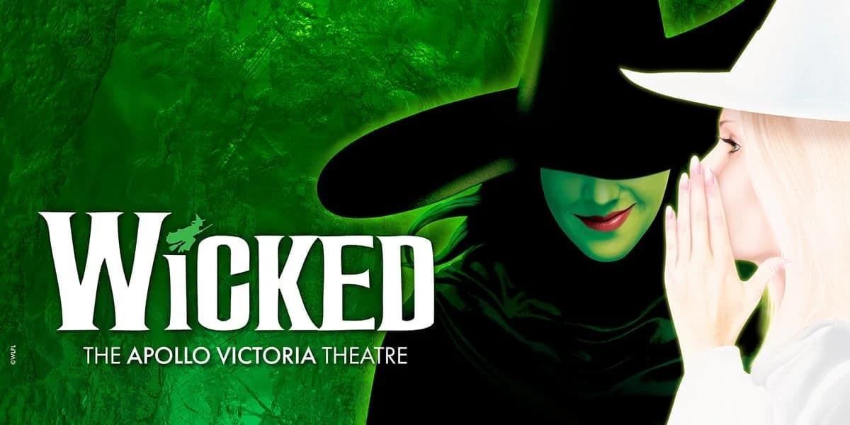 Green background. Text: [top] Wicked (the dot on the 'i' is a silhouette of a witch on a broom) [bottom] The Apollo Victoria Theatre Image within a circle frame Green witch in a black pointy hat and robe faces forward, side profile of a witch in contrasting white whispers to her.