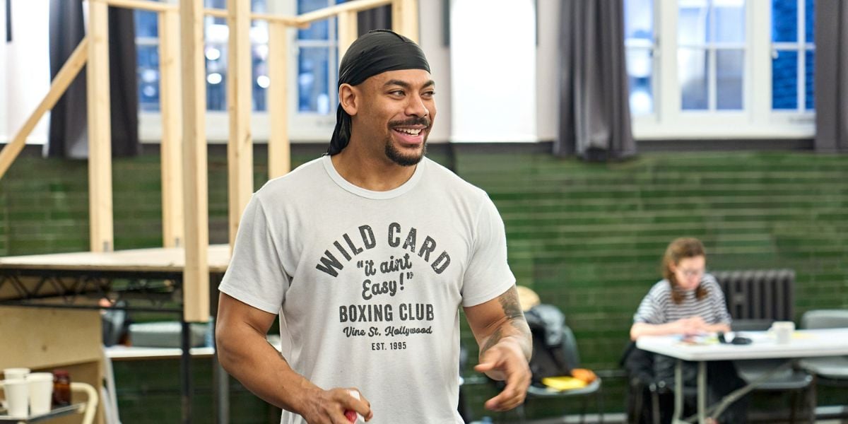 Aaron Pierre smiling rehearsing for One Flew Over the Cuckoo's Nest at the Old Vic.