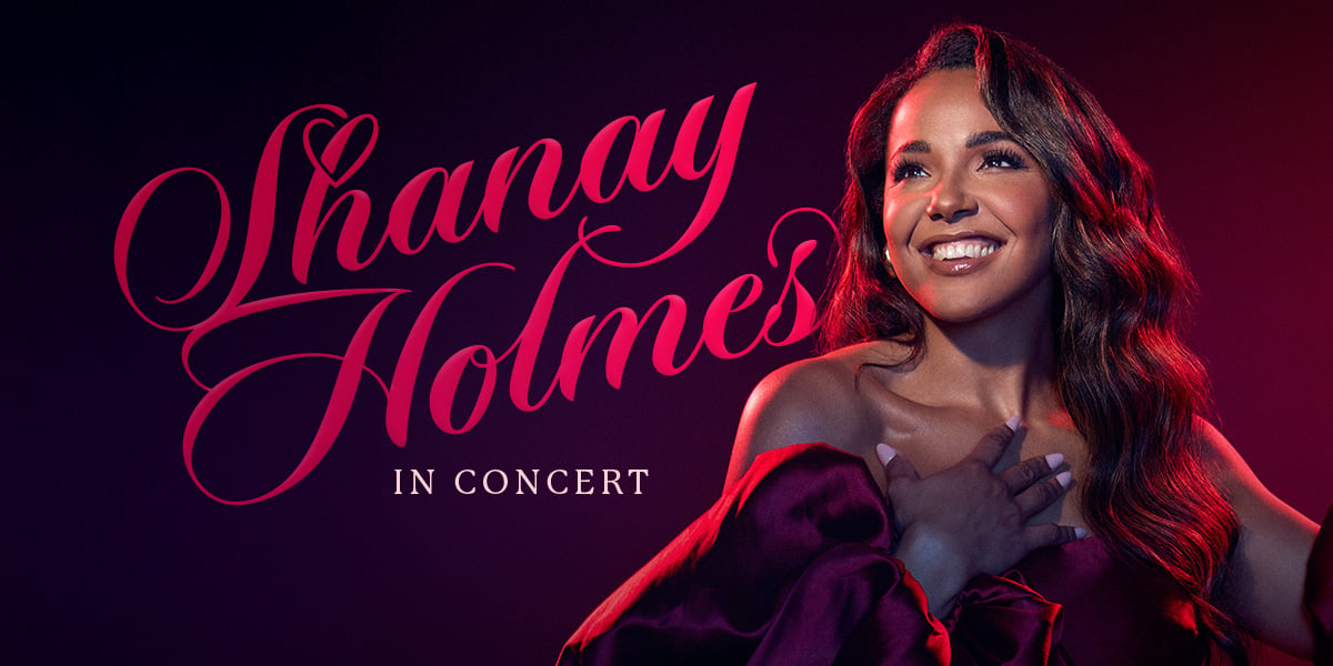 Shanay Holmes in Concert Live at Cadogan Hall artwork. Shanay is smiling, with her hand to her chest with elegant hollywood curls and a red gown.
