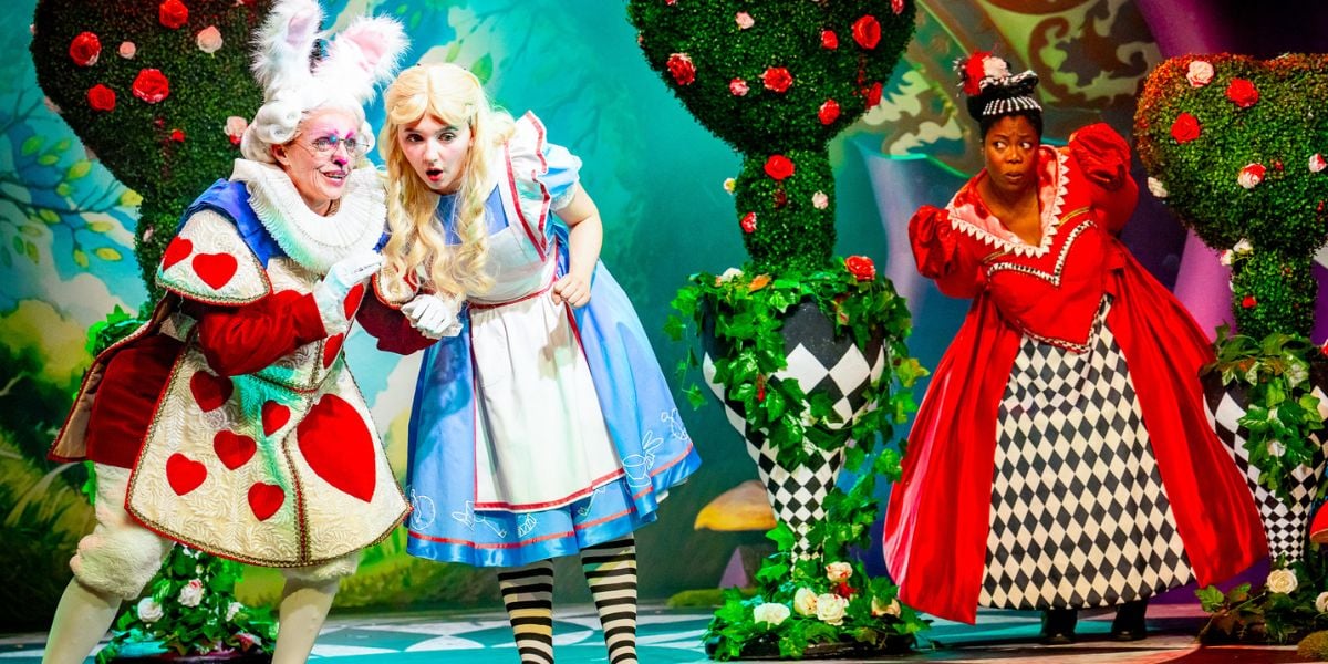 Alice in Wonderland at Riverside Studios. The Queen of Hearts listens in to Alice and the White Rabbit having a secret conversation.