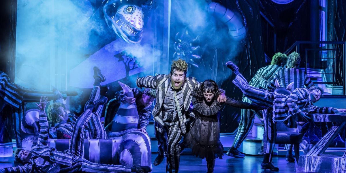 David Fynn as Beetlejuice and Hannah Nordberg as Lydia Deetz with the Company of Beetlejuice the Musical, West End © Johan Persson