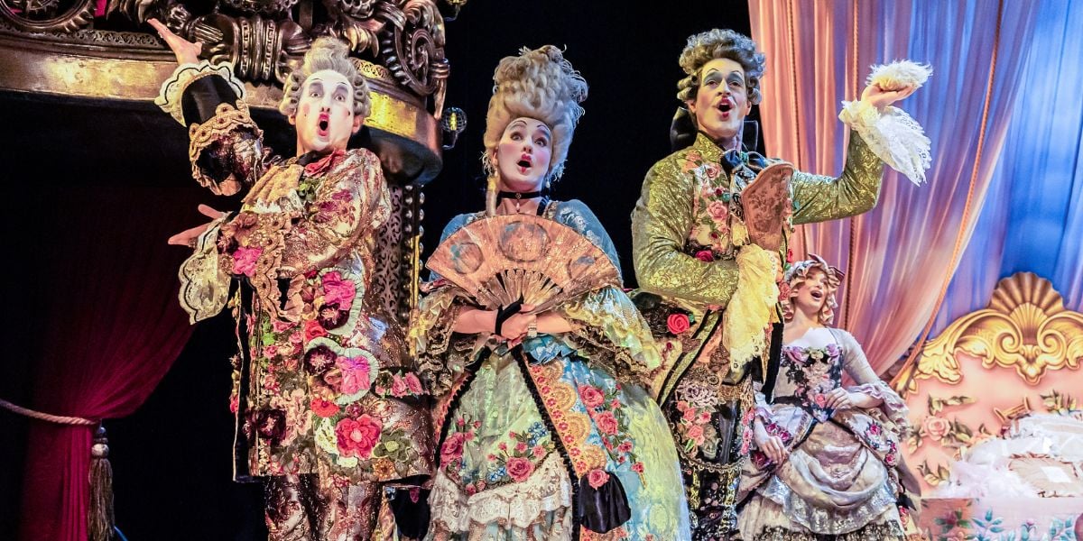 The company of Phantom of the Opera, wearing georgian costumes and tall grey wigs.