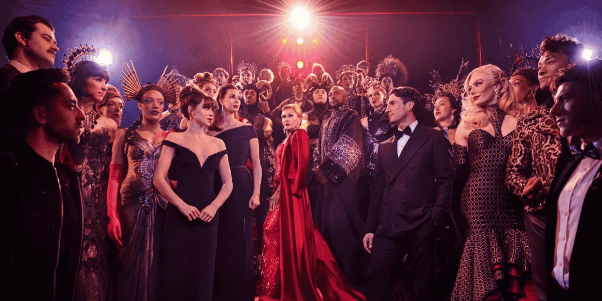 Vanessa Williams stands in a red dress among a crowd in The Devil Wears Prada musical in London.